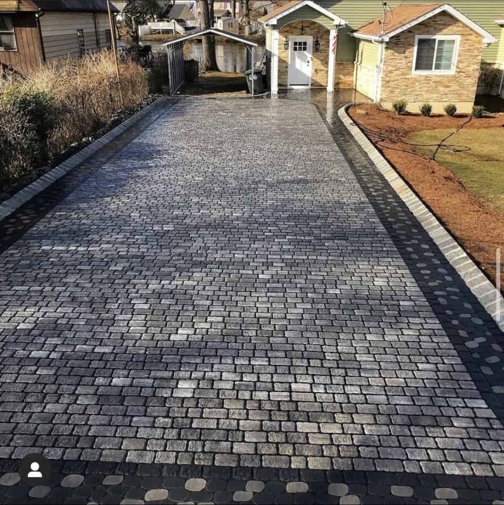 A recently installed stone driveway leading up to a covered garage.